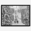 A fine art black and white mountain ski print showing a ski lift winding up the mountain with a stunning winter snow forest around it.
