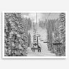 A fine art black and white mountain ski print showing a ski lift winding up the mountain with a stunning winter snow forest around it.