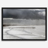 This fine art ocean photography print was taken in Pismo Beach, California, and showcases a distant view of an ocean pier and stormy clouds. Looking long and hard, you can see tens of surfers around the pier.