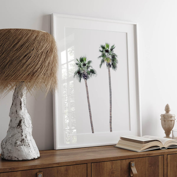 Minimalist fine art beach photography print of two tall palm trees against a white sky. Coastal decor.