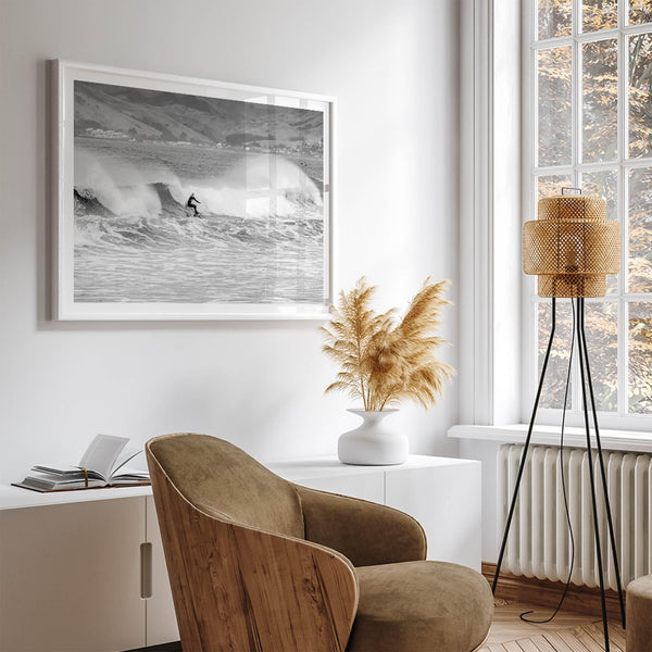 A black and white fine art surf print featuring a lone surfer riding the waves in Pismo Beach, California.