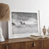 A black and white fine art surf print featuring a lone surfer riding the waves in Pismo Beach, California.