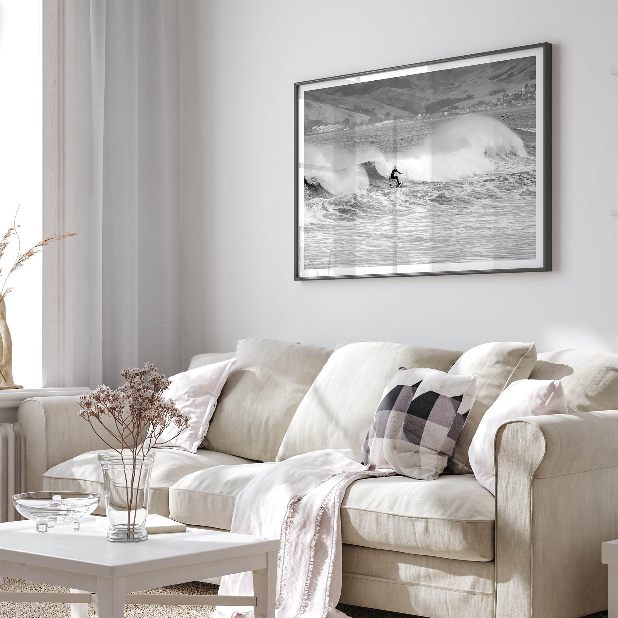 A black and white fine art surf print featuring a lone surfer riding the waves in Pismo Beach, California.
