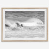 A black and white fine art surf print featuring a lone surfer riding the waves in Pismo Beach, California.