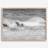 A black and white fine art surf print featuring a lone surfer riding the waves in Pismo Beach, California.