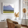 A stunning snow-covered mountain framed or unframed print from Grand Teton National Park with a beautiful horse grazing the grass in the forefront.