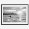 Surfer Wall Art featuring a lone surfer emerging from the ocean at Hanalei Bay in black-and-white photography.