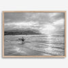 Surfer Wall Art featuring a lone surfer emerging from the ocean at Hanalei Bay in black-and-white photography.