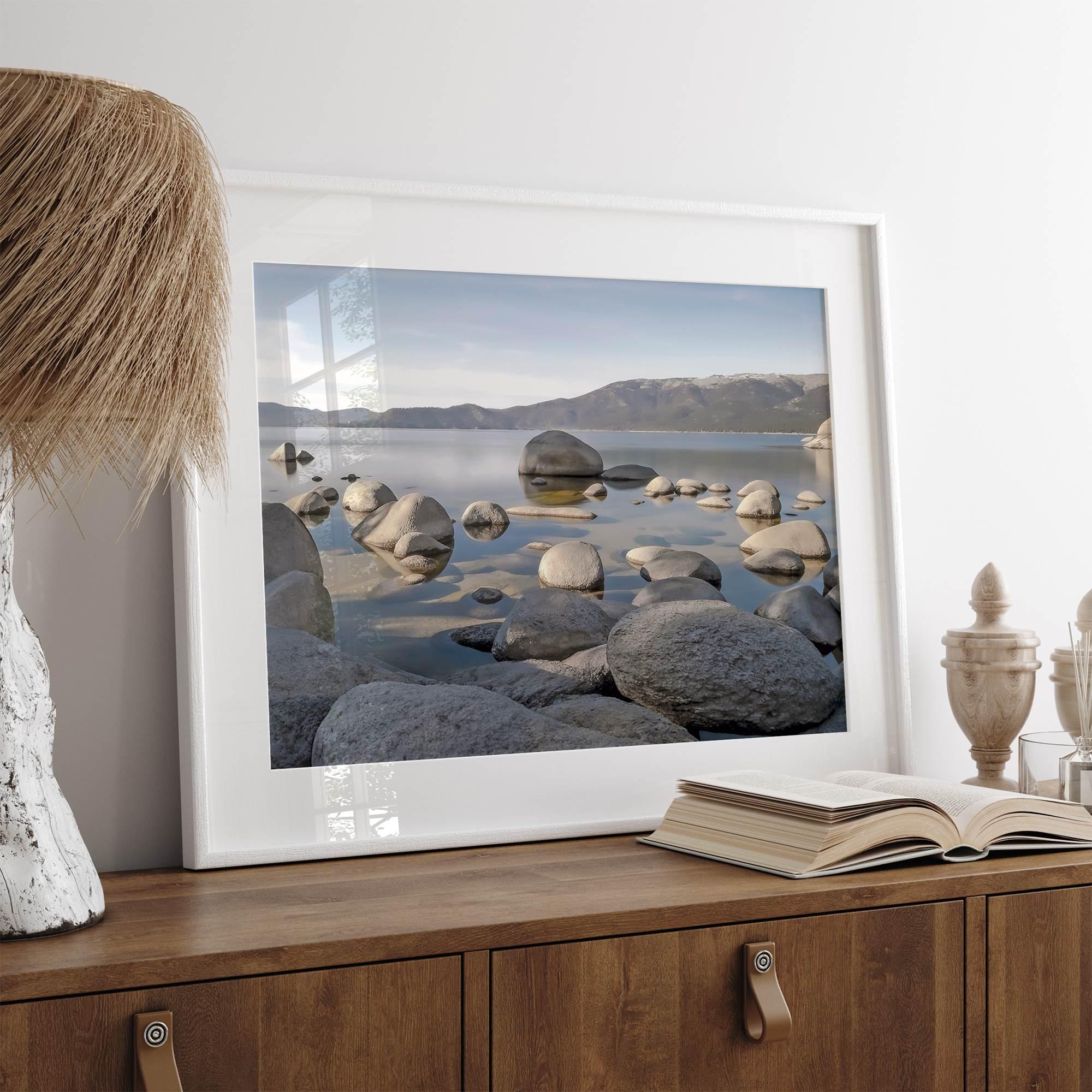 This breathtaking fine art Lake Tahoe print captures the perfect shape of the huge rocks that rise from the crystal-clear water, creating a beautiful contrast against the blue sky and the distant mountain range.