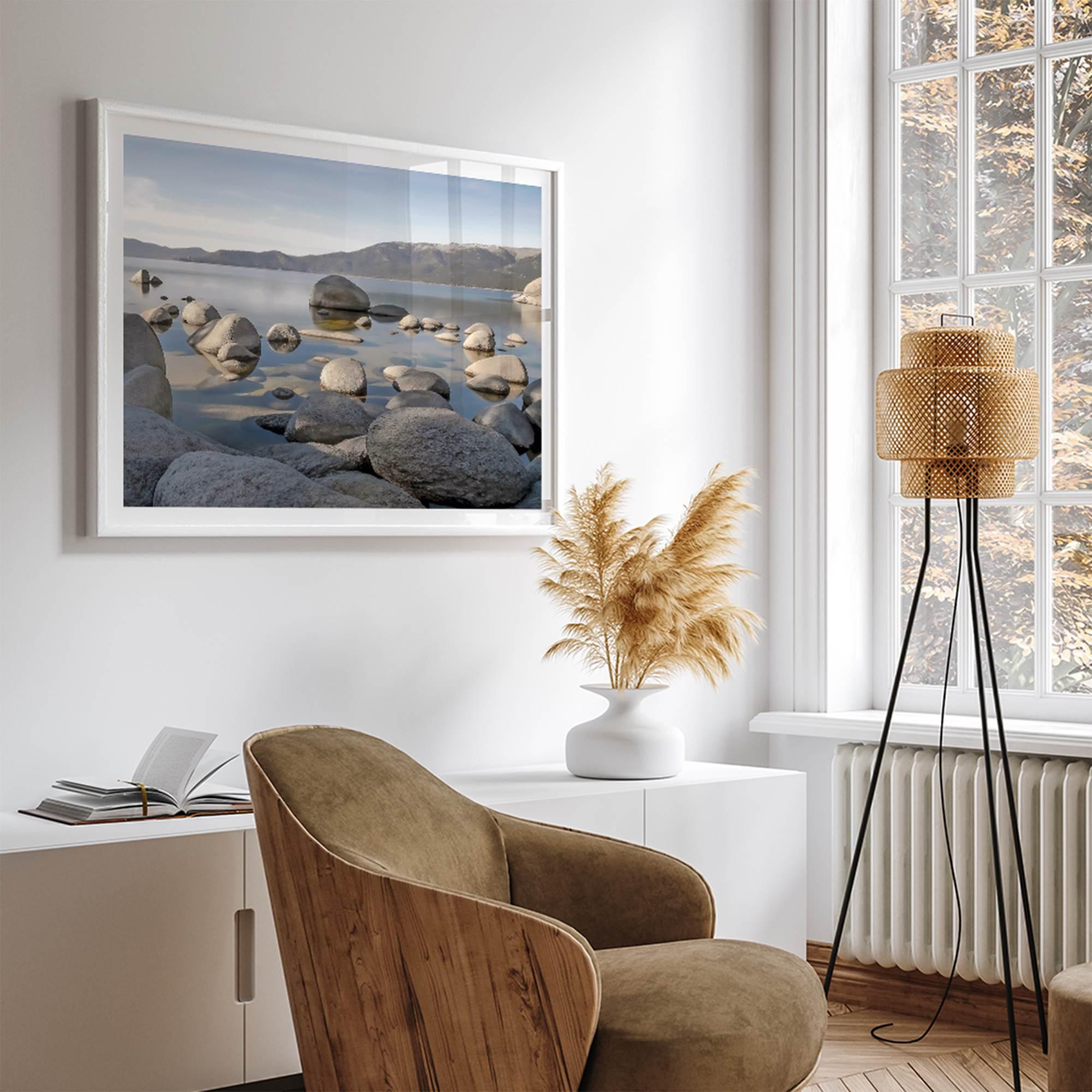 This breathtaking fine art Lake Tahoe print captures the perfect shape of the huge rocks that rise from the crystal-clear water, creating a beautiful contrast against the blue sky and the distant mountain range.