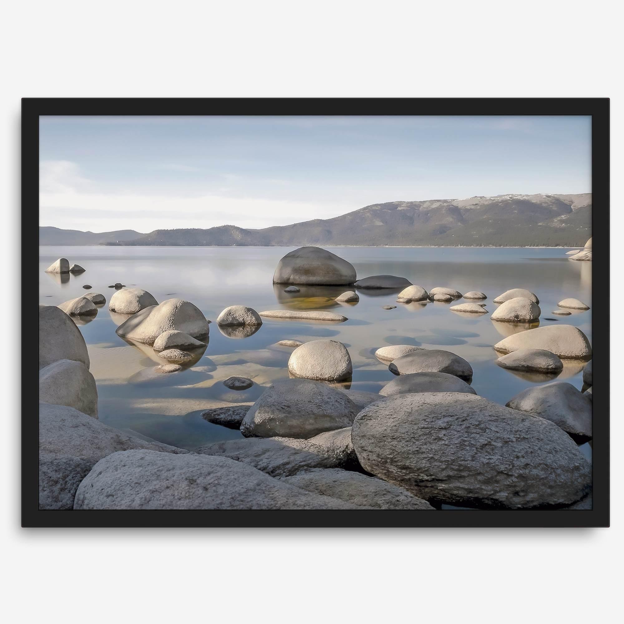 This breathtaking fine art Lake Tahoe print captures the perfect shape of the huge rocks that rise from the crystal-clear water, creating a beautiful contrast against the blue sky and the distant mountain range.