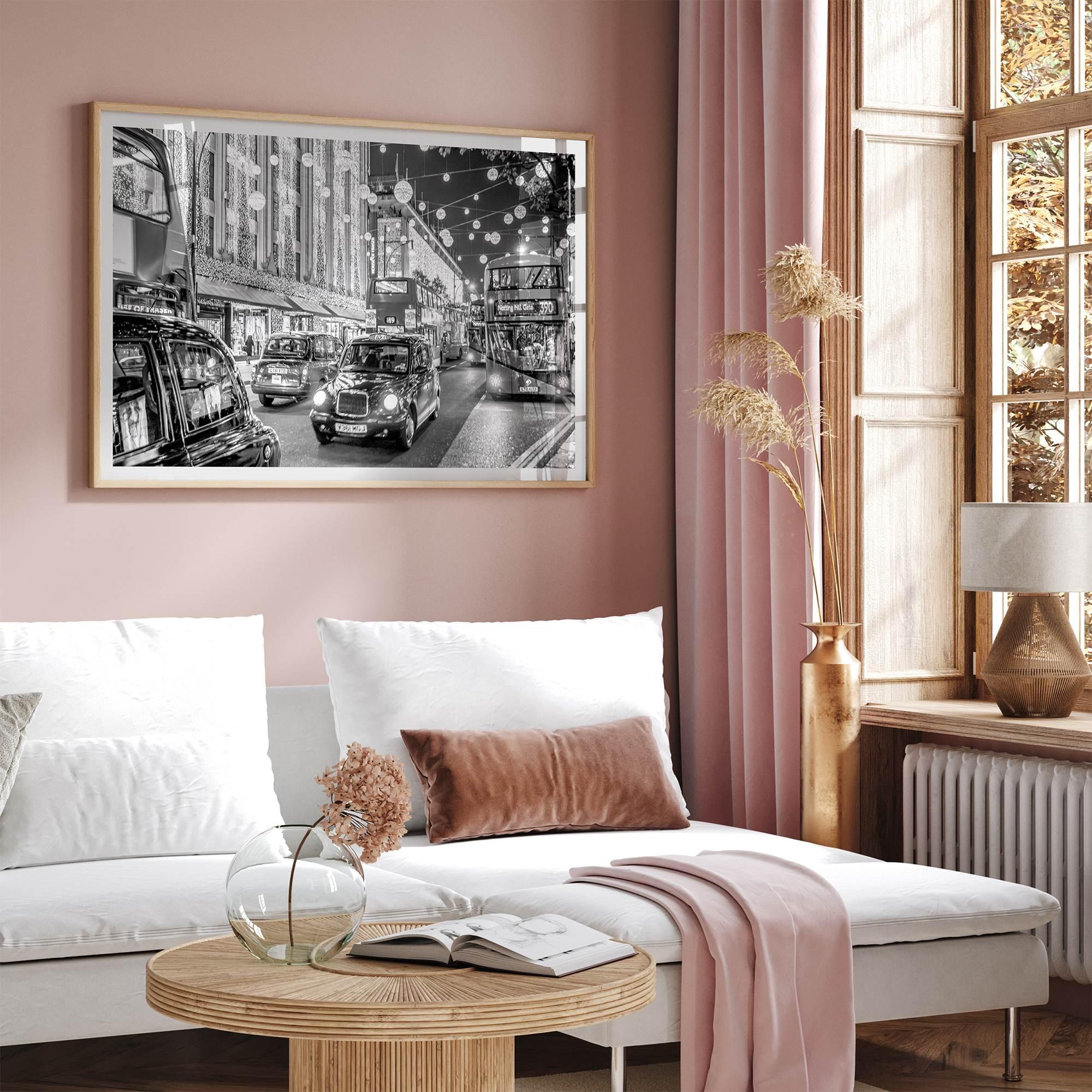 Black and white fine art photography print of a lively London street during Christmas, featuring double-decker buses, black taxis, and festive holiday lights.