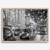 Black and white fine art photography print of a lively London street during Christmas, featuring double-decker buses, black taxis, and festive holiday lights.