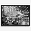 Black and white fine art photography print of a lively London street during Christmas, featuring double-decker buses, black taxis, and festive holiday lights.