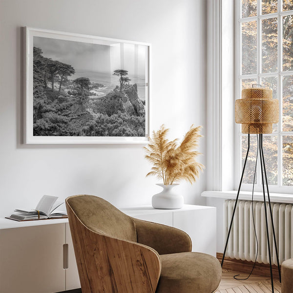 Black and white fine art coastal print featuring a lone cypress overlooking the ocean along 17-Mile Drive near Monterey, California. Available framed or unframed.