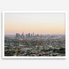 Los Angeles cityscape bathed in a vibrant sunset, showcasing the city's iconic buildings from above