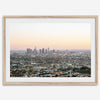 Los Angeles cityscape bathed in a vibrant sunset, showcasing the city's iconic buildings from above