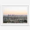 Los Angeles cityscape bathed in a vibrant sunset, showcasing the city's iconic buildings from above