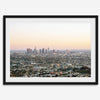 Los Angeles cityscape bathed in a vibrant sunset, showcasing the city's iconic buildings from above
