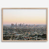 Los Angeles cityscape bathed in a vibrant sunset, showcasing the city's iconic buildings from above