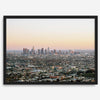 Los Angeles cityscape bathed in a vibrant sunset, showcasing the city's iconic buildings from above