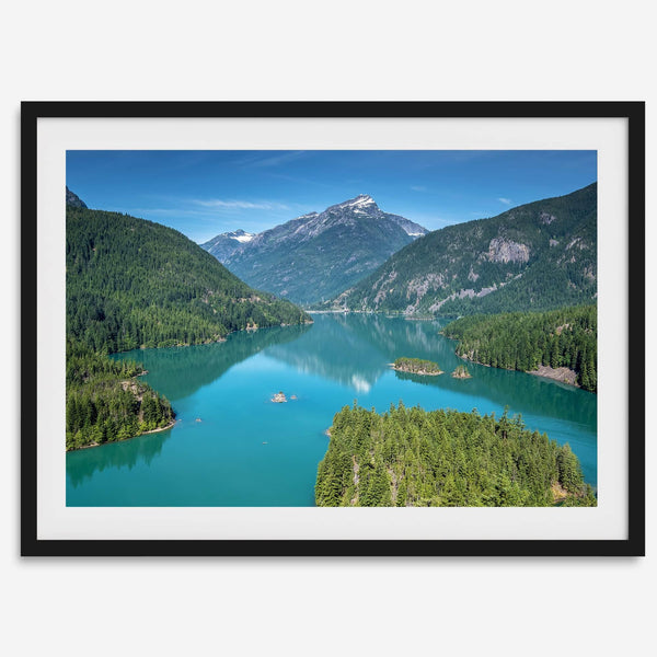 A fine art poster print of Diablo Lake in North Cascades National Park showcasing the deep blue water and the reflection of the surrounding mountains.