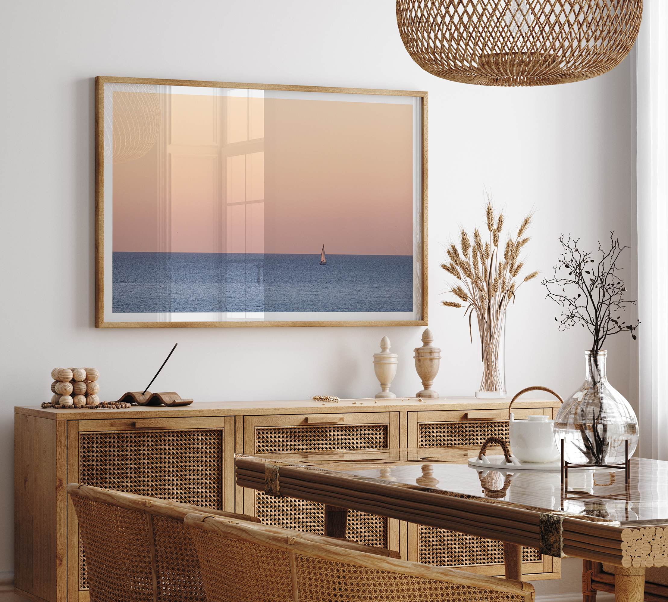 This stunning fine art ocean sunset photography print features a breathtaking scene of a boat against a golden and pink sky at sunset. The warm glow of the sunset and the natural beauty of the ocean and sky combine to create a soothing atmosphere.