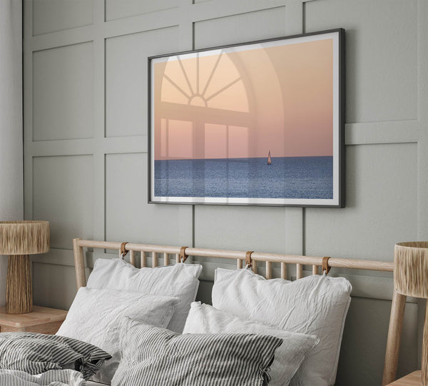 This stunning fine art ocean sunset photography print features a breathtaking scene of a boat against a golden and pink sky at sunset. The warm glow of the sunset and the natural beauty of the ocean and sky combine to create a soothing atmosphere.