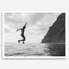Black and white fine art print of a man mid-jump into the ocean near the cliffs of Na Pali Coast, Kauai.