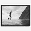 Black and white fine art print of a man mid-jump into the ocean near the cliffs of Na Pali Coast, Kauai.