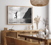 Black and white fine art print of a man mid-jump into the ocean near the cliffs of Na Pali Coast, Kauai.