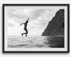 Black and white fine art print of a man mid-jump into the ocean near the cliffs of Na Pali Coast, Kauai.