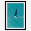 Aerial sailboat photography over turquoise San Francisco Bay near Berkeley, California, with a long sail-shaped shadow across the water.