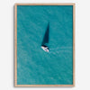 Aerial sailboat photography over turquoise San Francisco Bay near Berkeley, California, with a long sail-shaped shadow across the water.
