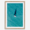 Aerial sailboat photography over turquoise San Francisco Bay near Berkeley, California, with a long sail-shaped shadow across the water.