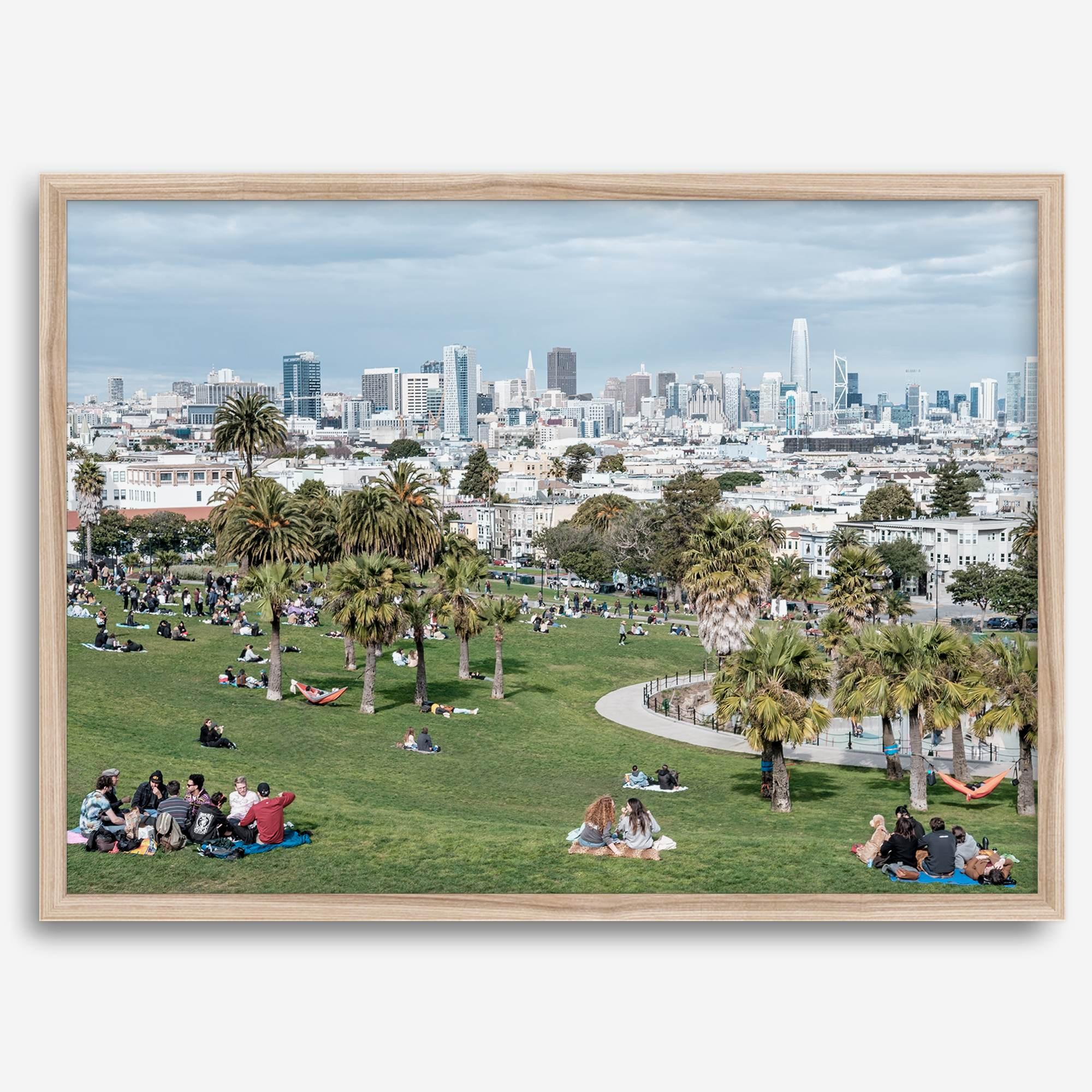 A fine art unframed or framed San Francisco print of Mission Dolores Park showcasing picnic blankets and people enjoying a quiet afternoon with the city skyline in the backdrop.