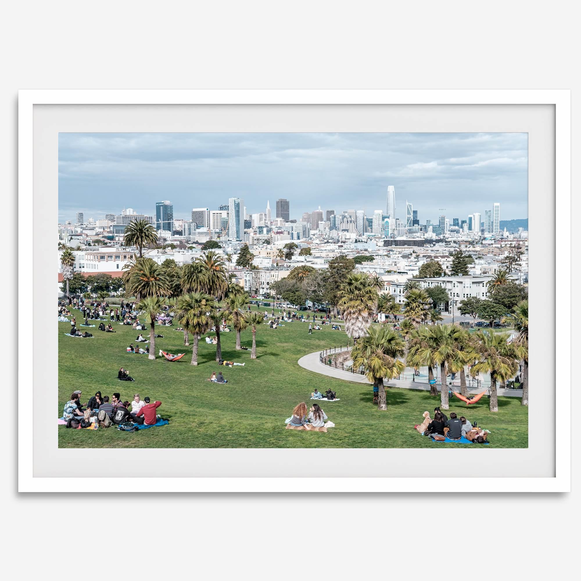 A fine art unframed or framed San Francisco print of Mission Dolores Park showcasing picnic blankets and people enjoying a quiet afternoon with the city skyline in the backdrop.