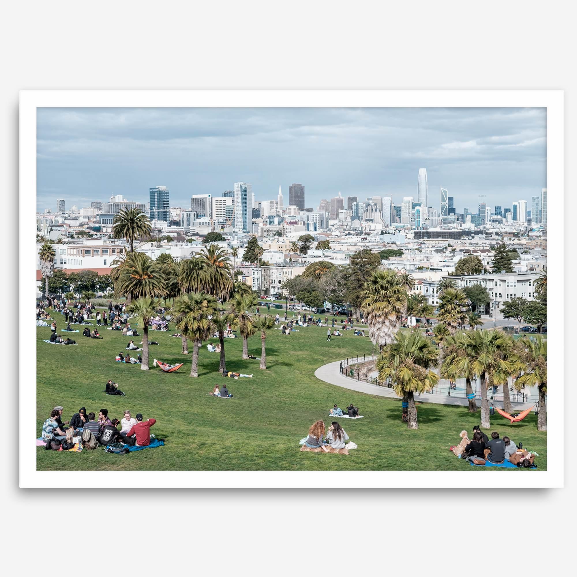 A fine art unframed or framed San Francisco print of Mission Dolores Park showcasing picnic blankets and people enjoying a quiet afternoon with the city skyline in the backdrop.