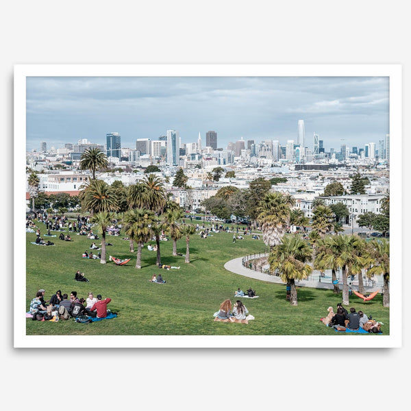 A fine art unframed or framed San Francisco print of Mission Dolores Park showcasing picnic blankets and people enjoying a quiet afternoon with the city skyline in the backdrop.