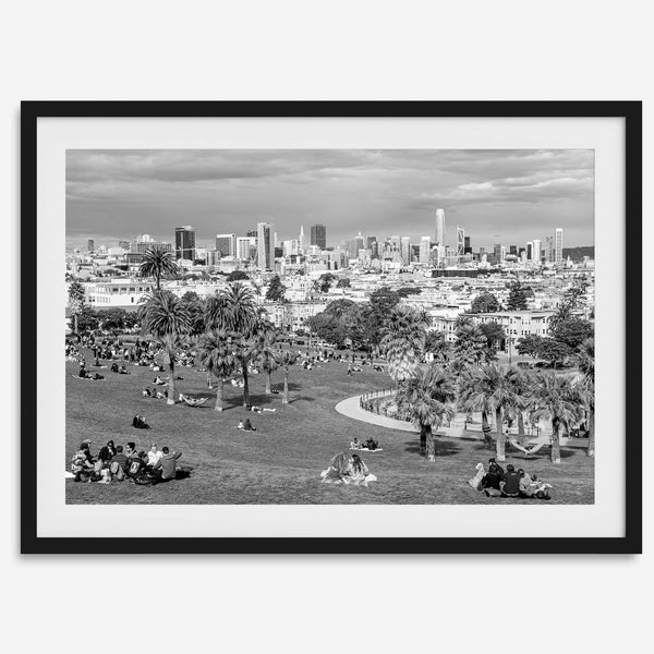 Black and white fine art print of Mission Dolores Park in San Francisco showcasing picnic blankets and people enjoying a quiet afternoon with the city skyline in the backdrop.