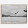 Diver leaping from a platform over a serene Austrian lake, with misty mountains in the background.