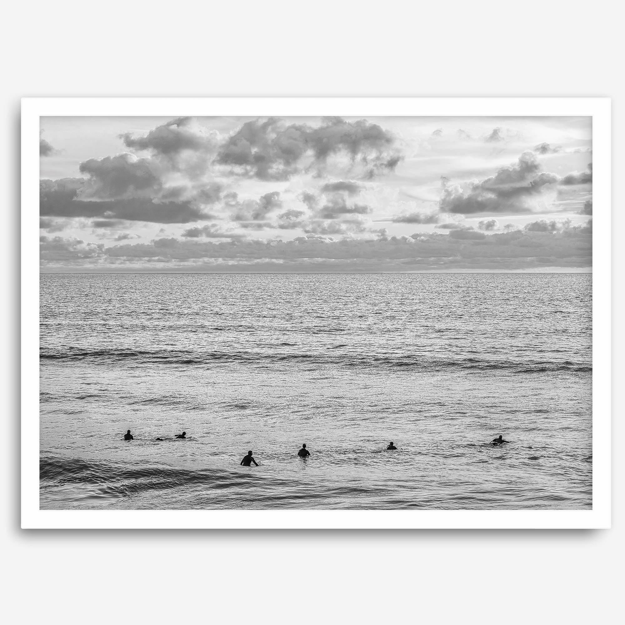 Black and white photo of surfers waiting in the water at sunset in Pismo Beach, California – fine art surf print.