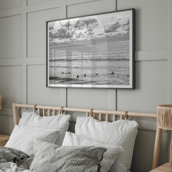 Black and white photo of surfers waiting in the water at sunset in Pismo Beach, California – fine art surf print.