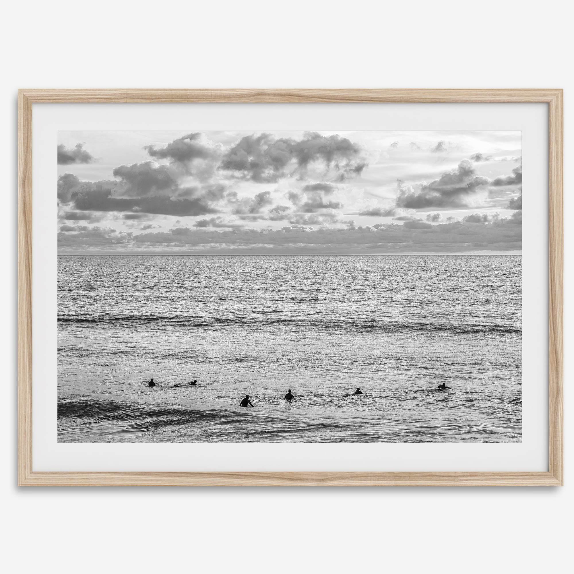 Black and white photo of surfers waiting in the water at sunset in Pismo Beach, California – fine art surf print.