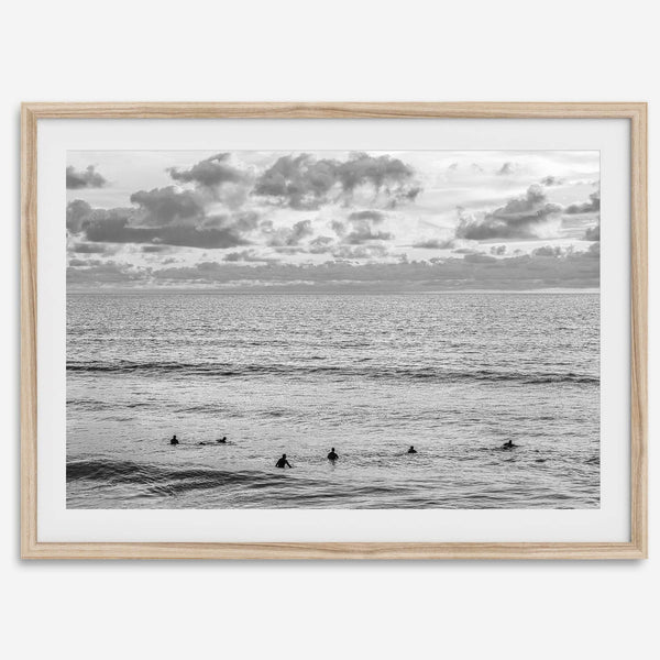 Black and white photo of surfers waiting in the water at sunset in Pismo Beach, California – fine art surf print.