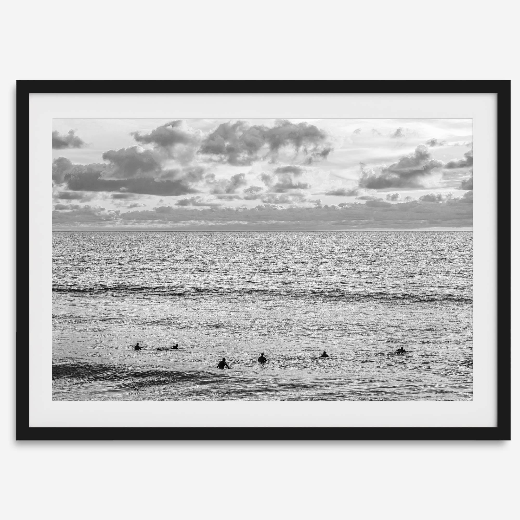 Black and white photo of surfers waiting in the water at sunset in Pismo Beach, California – fine art surf print.