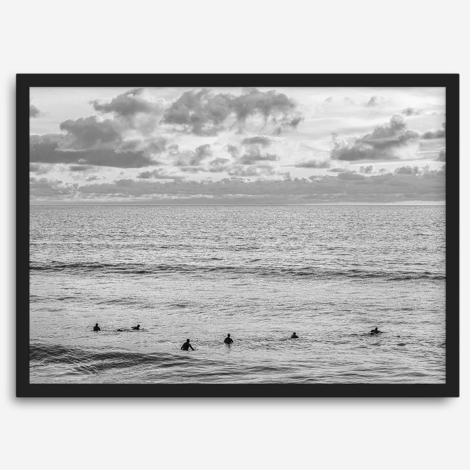 Black and white photo of surfers waiting in the water at sunset in Pismo Beach, California – fine art surf print.