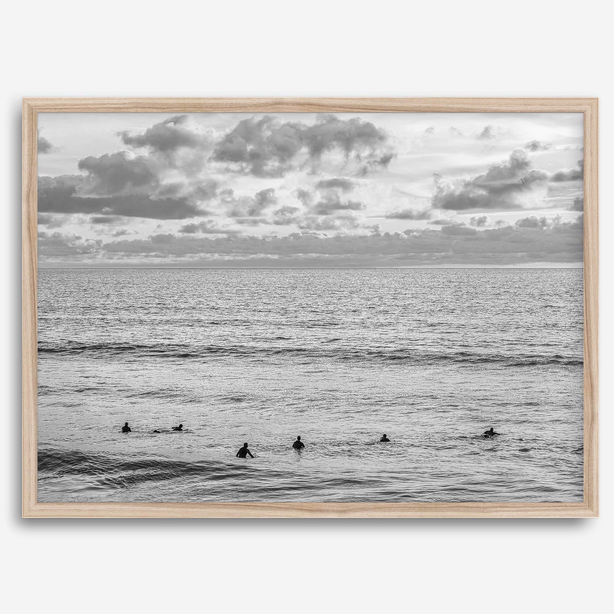 Black and white photo of surfers waiting in the water at sunset in Pismo Beach, California – fine art surf print.