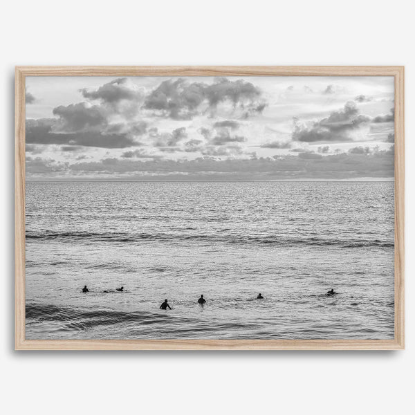 Black and white photo of surfers waiting in the water at sunset in Pismo Beach, California – fine art surf print.