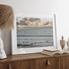 Sunset surf wall art featuring surfers’ silhouettes at Pismo Beach, California, with golden light, calm ocean, and vibrant sunset sky.